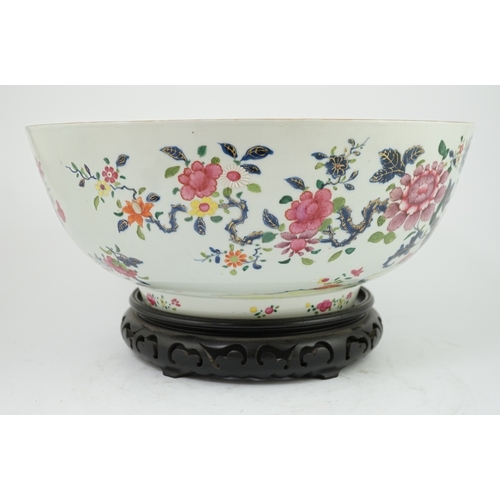 1402 - A large Chinese famille rose punch bowl, Qianlong period, the exterior painted with flowers in a fen... 