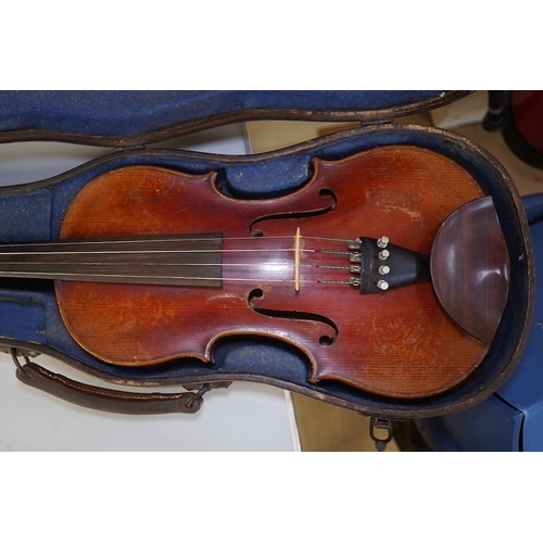 1417 - A late 19th century violin, bears fake Stradivarius label, cased, back measures 36cm. Condition - fa... 