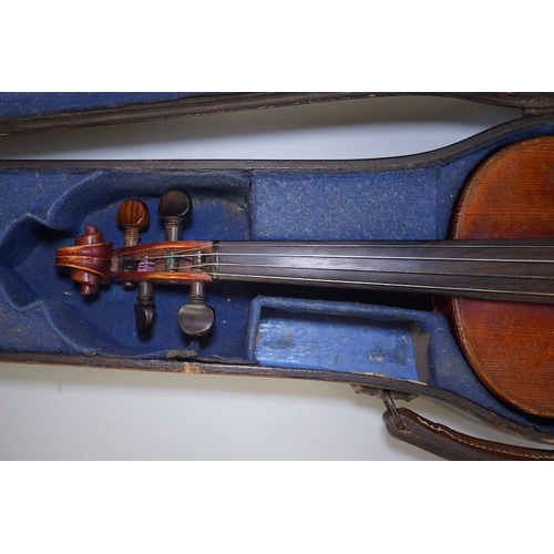 1417 - A late 19th century violin, bears fake Stradivarius label, cased, back measures 36cm. Condition - fa... 