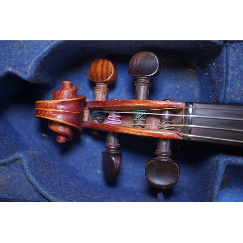 1417 - A late 19th century violin, bears fake Stradivarius label, cased, back measures 36cm. Condition - fa... 