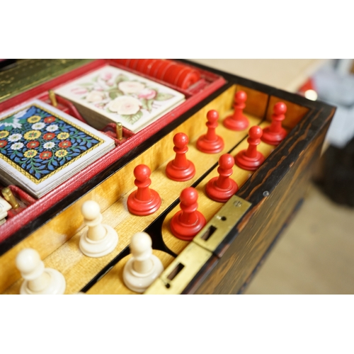 1449 - A Victorian coromandel games box with accessories, ivory chess pieces and counters, box 36cm wide x ... 