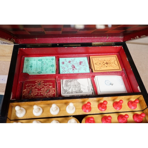 1449 - A Victorian coromandel games box with accessories, ivory chess pieces and counters, box 36cm wide x ... 