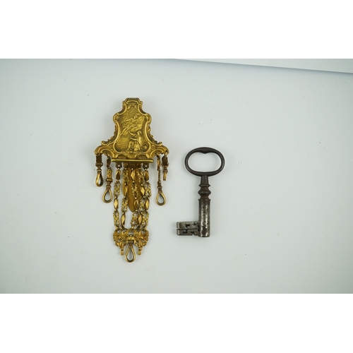 1459 - A late 18th century German gilt metal chatelaine and a steel key, chaterlaine 14cm long. Condition -... 