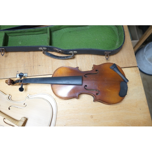 1492 - Early 20th century ¾ size violin, unlabelled, cased, together with a violin table, back and scroll. ... 