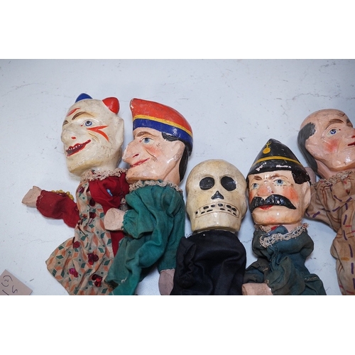 1494 - Eight early 20th century puppets, comprising of carved wooden heads, lower legs and feet, and held t... 