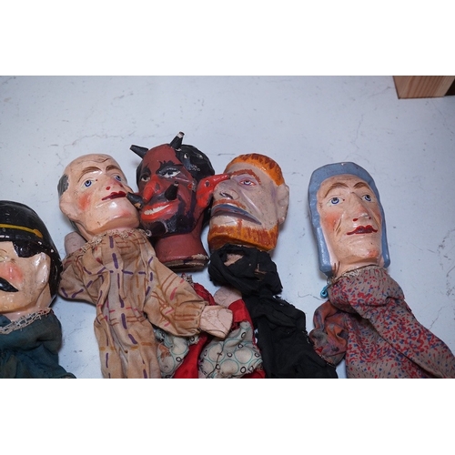 1494 - Eight early 20th century puppets, comprising of carved wooden heads, lower legs and feet, and held t... 