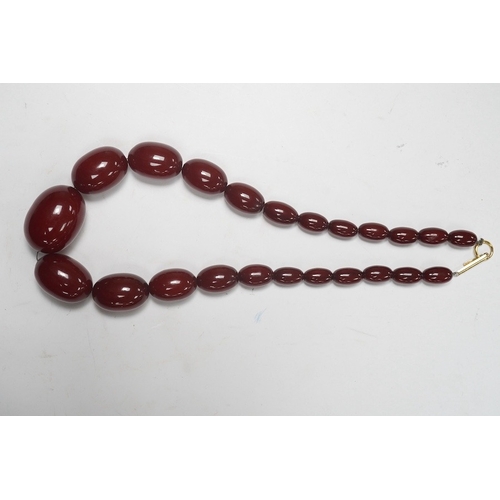 1901 - A single strand graduated oval simulated cherry amber necklace, 38cm, gross weight 47 grams. Conditi... 