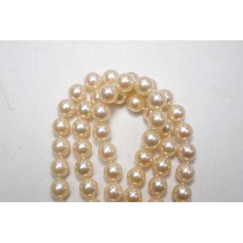 1906 - A modern triple strand culture pearl necklace, with emerald cluster set 14k clasp, 48cm. Condition -... 