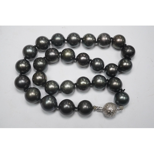 1907 - A modern single strand Tahitian black pearl necklace, with diamond cluster set 14k white metal spher... 