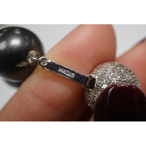 1907 - A modern single strand Tahitian black pearl necklace, with diamond cluster set 14k white metal spher... 