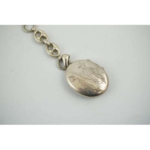 1926 - A late Victorian white metal oval locket with Japonaiserie decoration, 47mm, on a white metal chain.... 