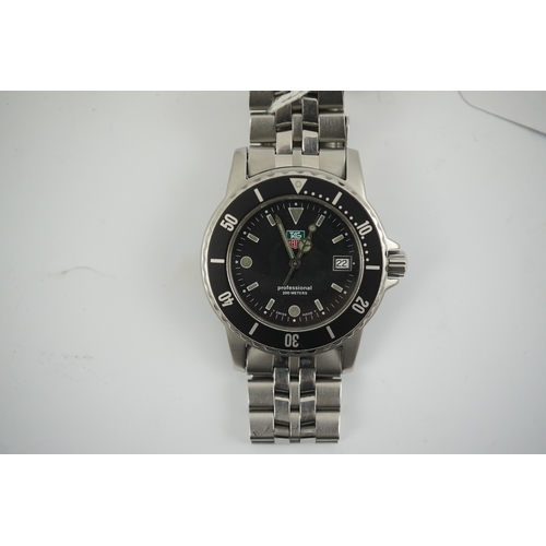 106 - A gentleman's recent stainless steel Tag Heuer Professional quartz wrist watch, on a Tag Heuer stain... 