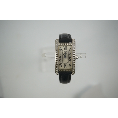 109 - A lady's modern 18ct white gold and diamond set Cartier Tank Americaine quartz wrist watch, with cur... 