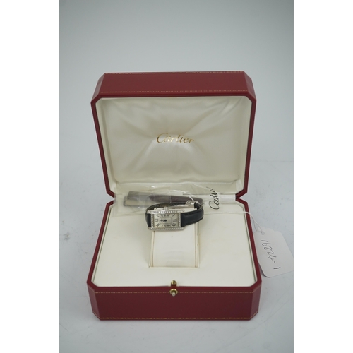 109 - A lady's modern 18ct white gold and diamond set Cartier Tank Americaine quartz wrist watch, with cur... 