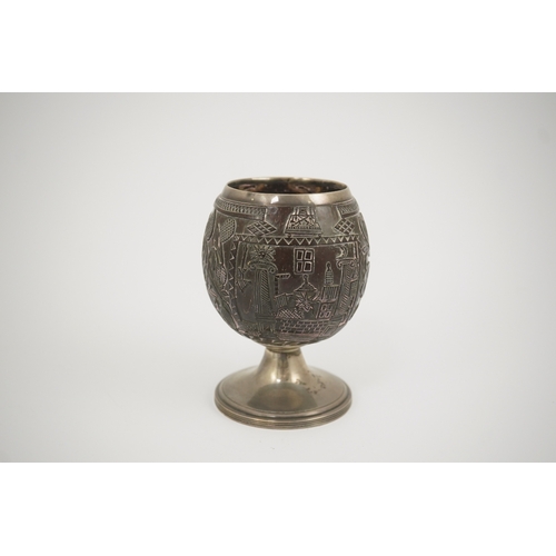 11 - A George III silver mounted 'Masonic' coconut cup, maker GW, carved throughout with Masonic emblems,... 