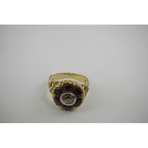 111 - A Georgian gold, ruby and diamond circular cluster ring, set with a central old round cut diamond, b... 