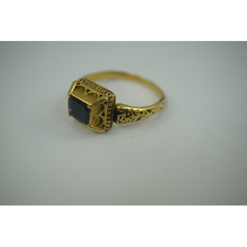 112 - An antique high carat gold, black enamel and later? collet set cushion cut sapphire set 'poison' rin... 