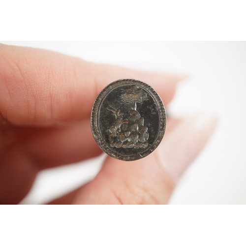 114 - An early 18th century silver and gold signet ring, embossed with an armorial, size R, together with ... 