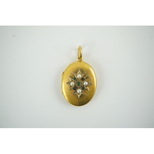 122 - A Victorian gold, split pearl and emerald cluster set oval locket, overall 36mm, gross weight 7.6 gr... 