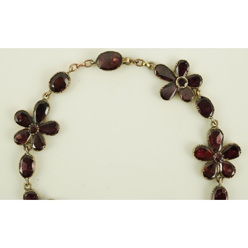 124 - An early Victorian gold and foil backed garnet cluster set bracelet, of foliate design, 17cm, gross ... 