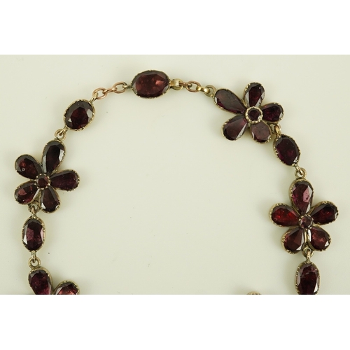 124 - An early Victorian gold and foil backed garnet cluster set bracelet, of foliate design, 17cm, gross ... 