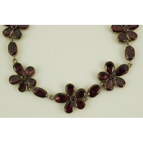 124 - An early Victorian gold and foil backed garnet cluster set bracelet, of foliate design, 17cm, gross ... 