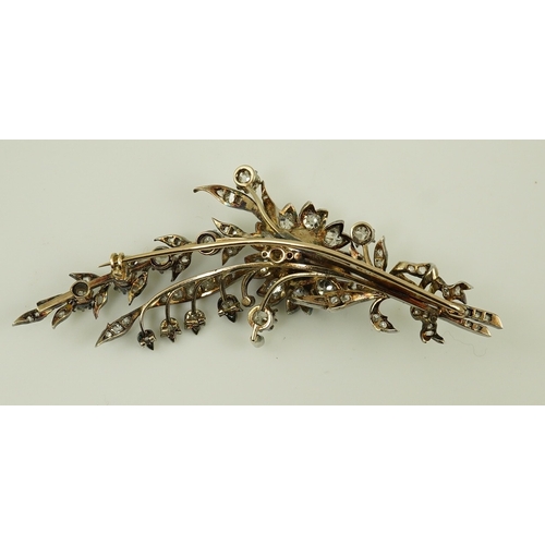 127 - A Victorian gold, silver and diamond cluster foliate spray brooch, set with old mine and rose cut di... 