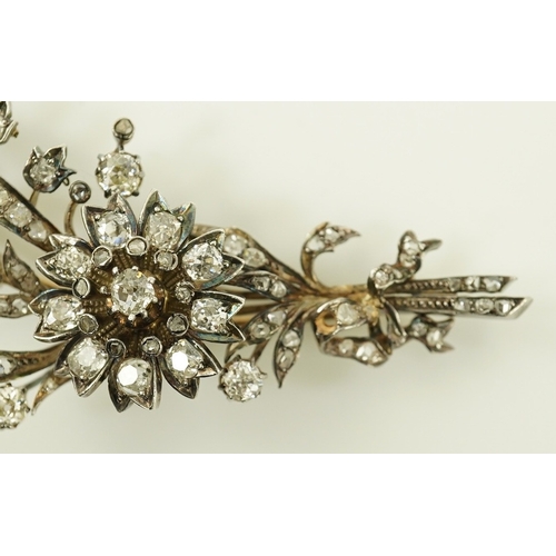 127 - A Victorian gold, silver and diamond cluster foliate spray brooch, set with old mine and rose cut di... 