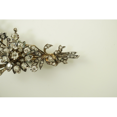 127 - A Victorian gold, silver and diamond cluster foliate spray brooch, set with old mine and rose cut di... 