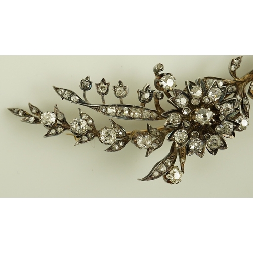 127 - A Victorian gold, silver and diamond cluster foliate spray brooch, set with old mine and rose cut di... 