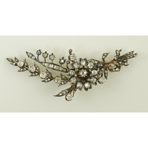 127 - A Victorian gold, silver and diamond cluster foliate spray brooch, set with old mine and rose cut di... 