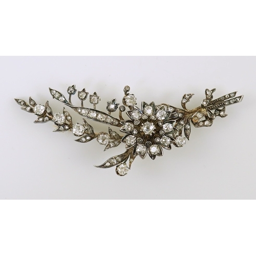 127 - A Victorian gold, silver and diamond cluster foliate spray brooch, set with old mine and rose cut di... 