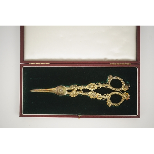 13 - A cased pair of William IV Paul Storr silver gilt grape shears, in later case, with foliate handles,... 