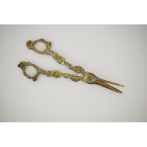 13 - A cased pair of William IV Paul Storr silver gilt grape shears, in later case, with foliate handles,... 