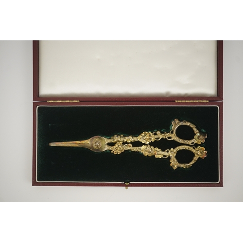 13 - A cased pair of William IV Paul Storr silver gilt grape shears, in later case, with foliate handles,... 