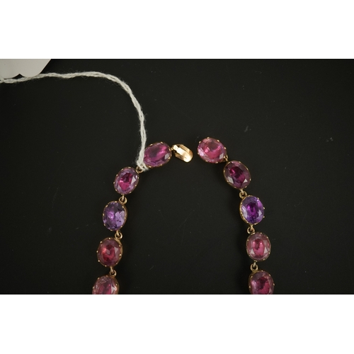 133 - A 19th century gold and graduated oval cut foil backed amethyst or rock crystal set riviere necklace... 