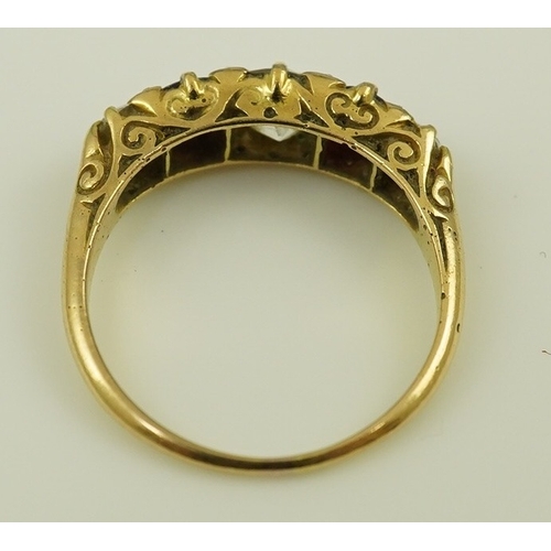 139 - A late Victorian 18ct gold, two stone ruby and three stone diamond set half hoop ring, with carved s... 