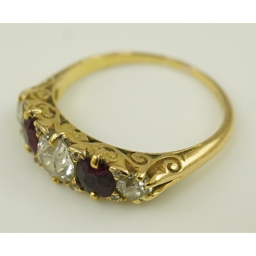 139 - A late Victorian 18ct gold, two stone ruby and three stone diamond set half hoop ring, with carved s... 