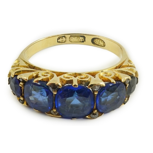 141 - A late Victorian 18ct gold and graduated five stone blue doublet set half hoop ring, with rose cut d... 