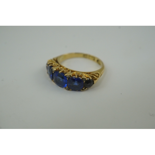 141 - A late Victorian 18ct gold and graduated five stone blue doublet set half hoop ring, with rose cut d... 