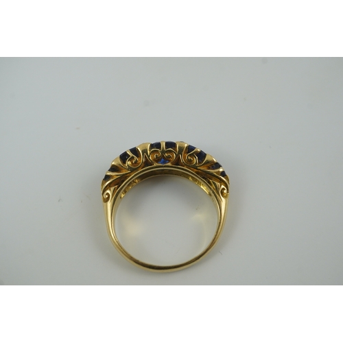 141 - A late Victorian 18ct gold and graduated five stone blue doublet set half hoop ring, with rose cut d... 