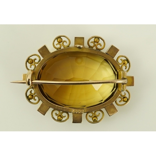 142 - A late Victorian 9ct gold, citrine and seed pearl cluster set oval brooch, with scroll and sphere bo... 