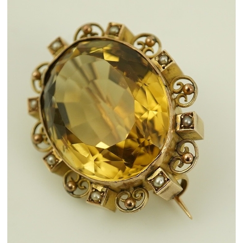 142 - A late Victorian 9ct gold, citrine and seed pearl cluster set oval brooch, with scroll and sphere bo... 