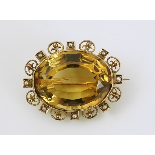 142 - A late Victorian 9ct gold, citrine and seed pearl cluster set oval brooch, with scroll and sphere bo... 