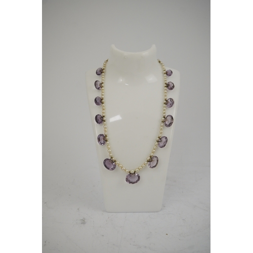 143 - A 19th century pearl and graduated fifteen stone oval cut amethyst set drop necklace, with a gold ba... 