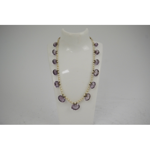 143 - A 19th century pearl and graduated fifteen stone oval cut amethyst set drop necklace, with a gold ba... 