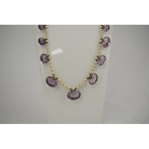 143 - A 19th century pearl and graduated fifteen stone oval cut amethyst set drop necklace, with a gold ba... 