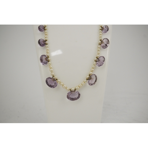 143 - A 19th century pearl and graduated fifteen stone oval cut amethyst set drop necklace, with a gold ba... 