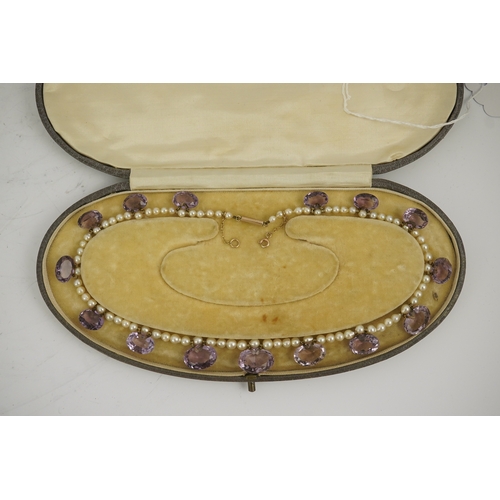 143 - A 19th century pearl and graduated fifteen stone oval cut amethyst set drop necklace, with a gold ba... 