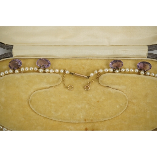 143 - A 19th century pearl and graduated fifteen stone oval cut amethyst set drop necklace, with a gold ba... 